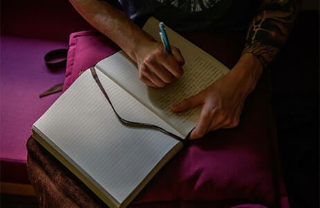 Hands of person writing in a journal