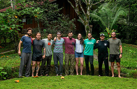 Group of retreat attendees with their arms around each other's shoulders